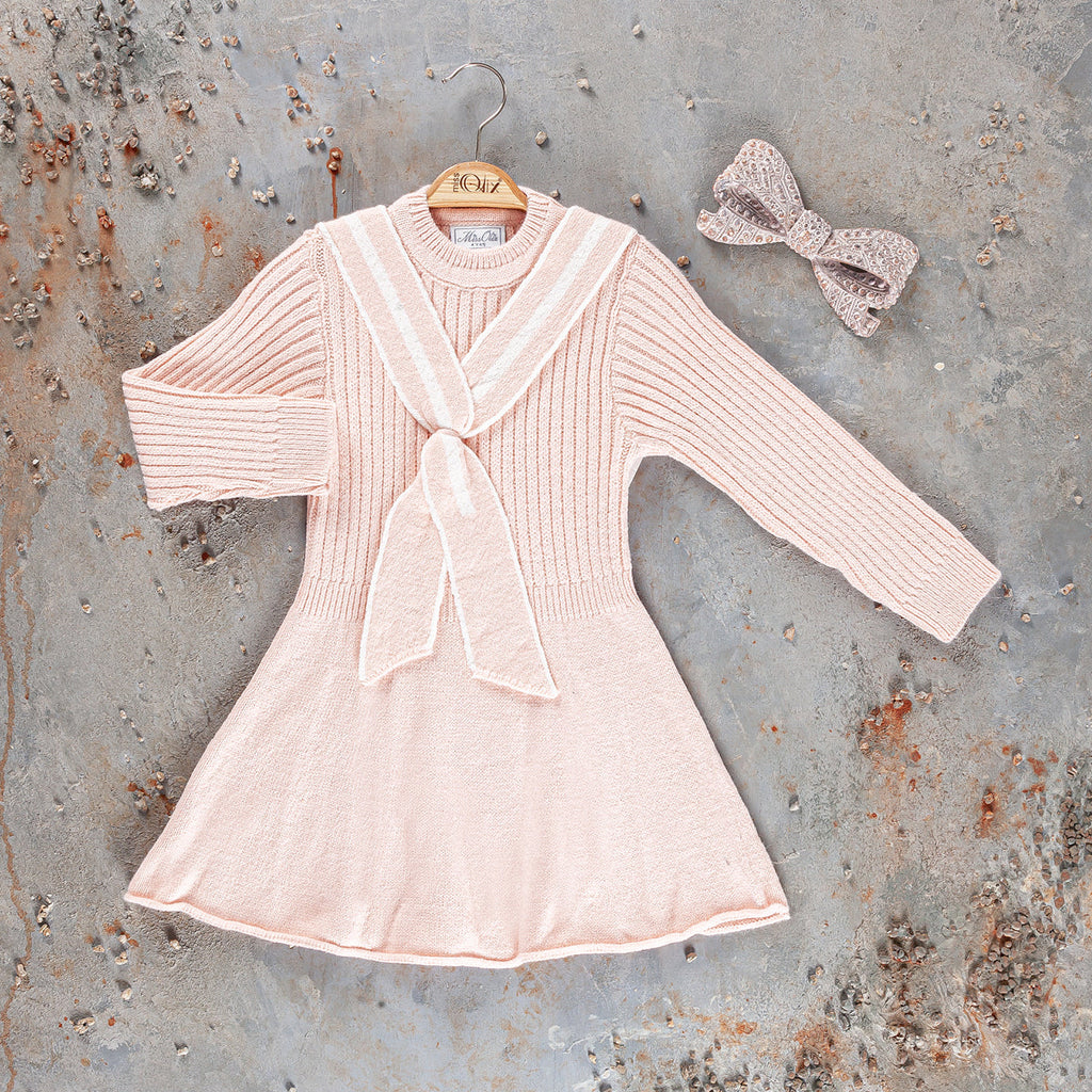 Girls knit dress in light pink with long sleeves, V-collar bow, and flare hem