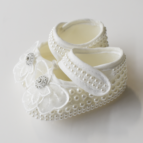 Baby pearl-trim booties in offwhite with lace flower and bead details, side view