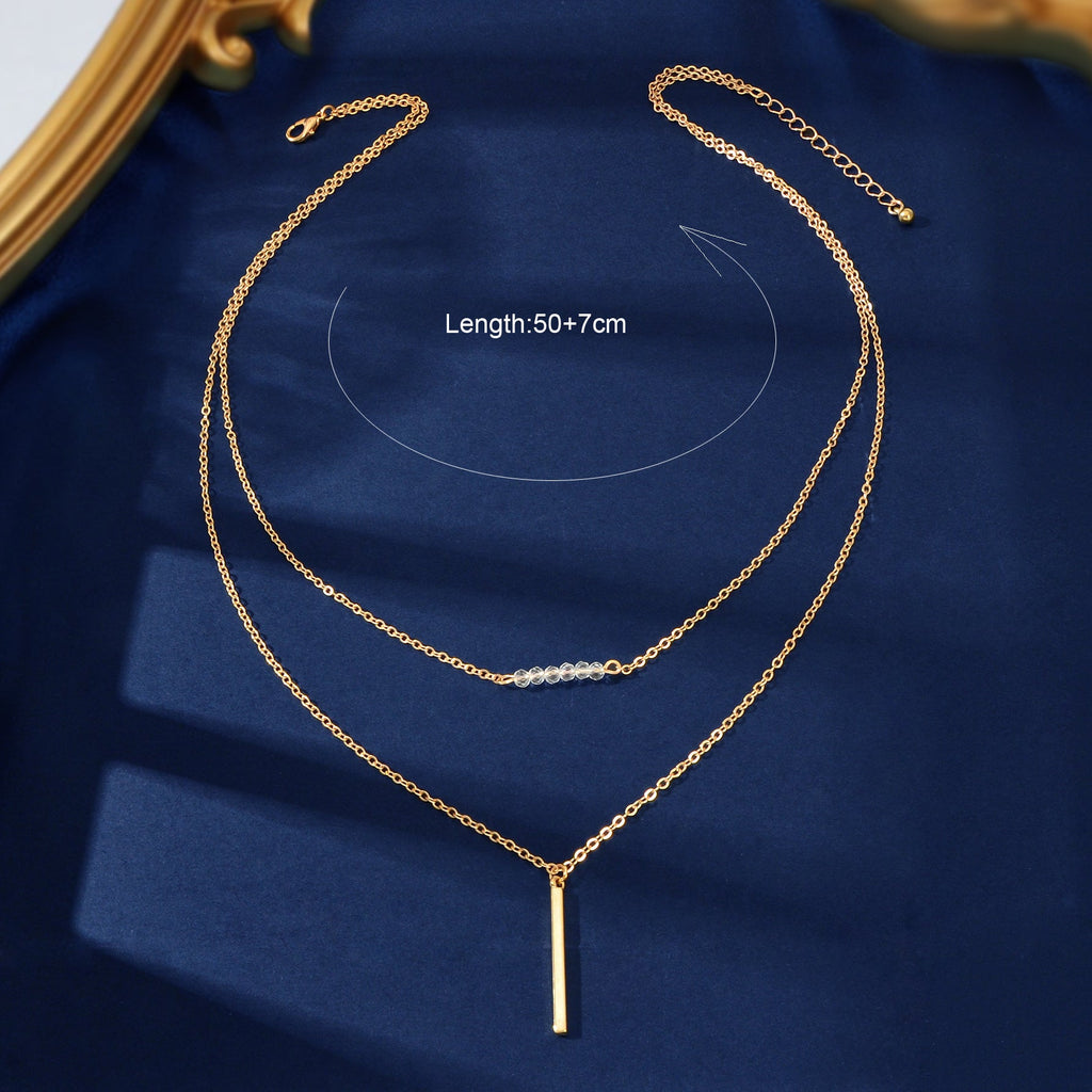 Gold-tone double-layer chain necklace with two strands and vertical bar charm