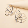 Silver hollow butterfly stud earrings with rhinestone cluster, pierced design