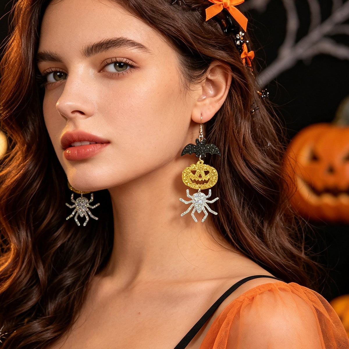 Halloween drop earrings with black bat, gold glitter pumpkin, and silver glitter spider charms