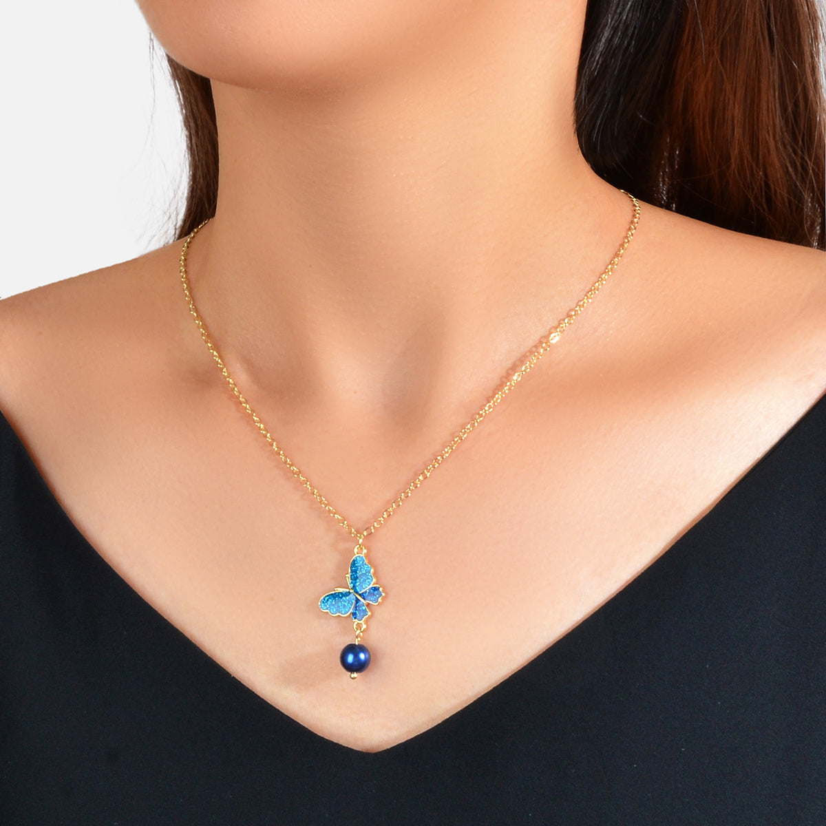Blue butterfly pendant necklace with dark blue bead drop and gold chain