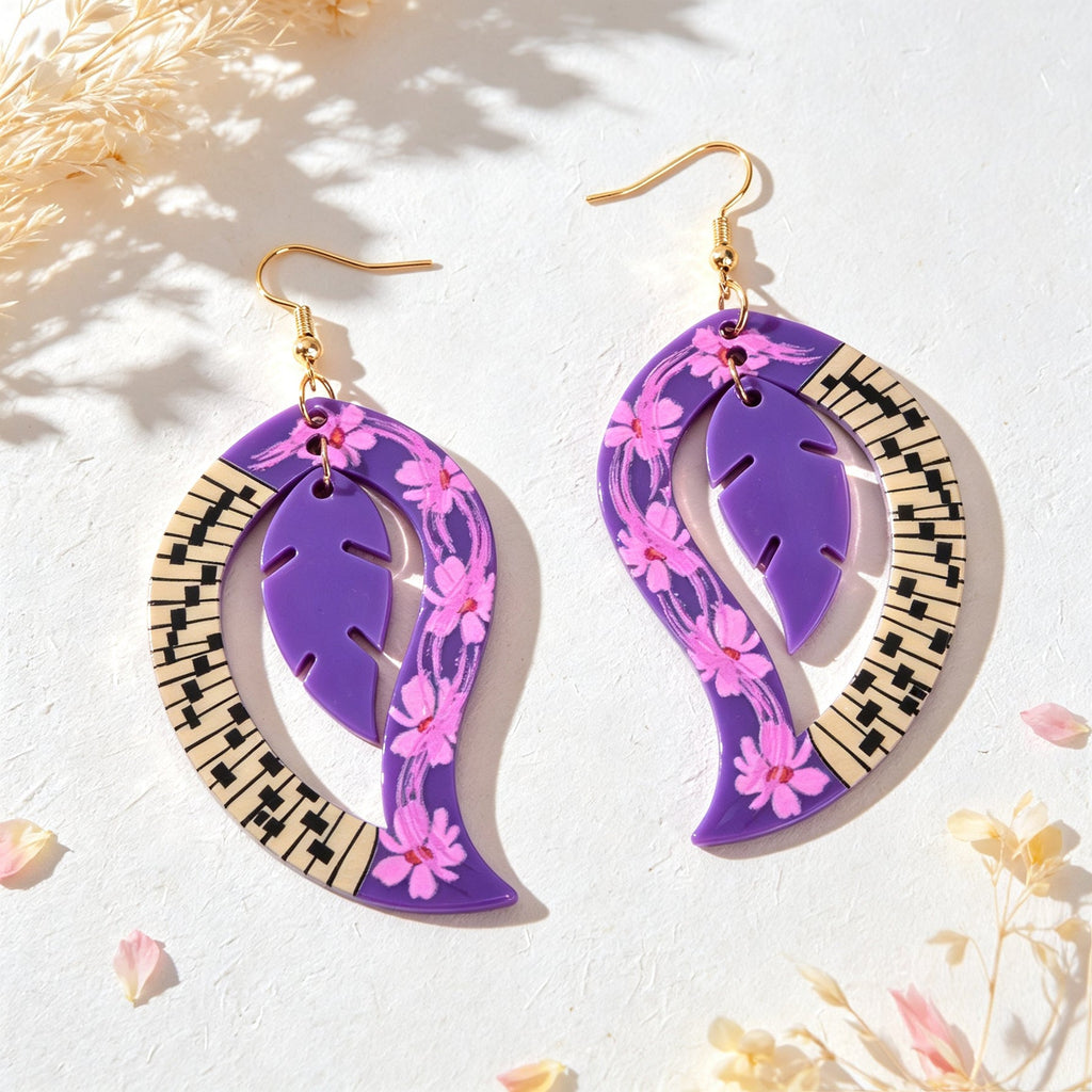 Pair of purple floral leaf dangle earrings with gold hooks and piano-key border
