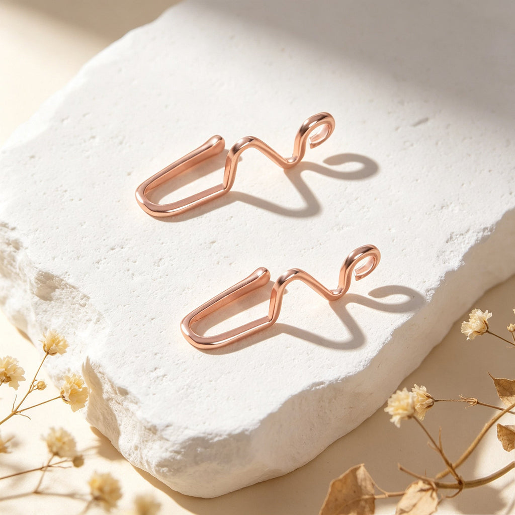 Rose gold wave ear cuffs, set of two, close view on white stone