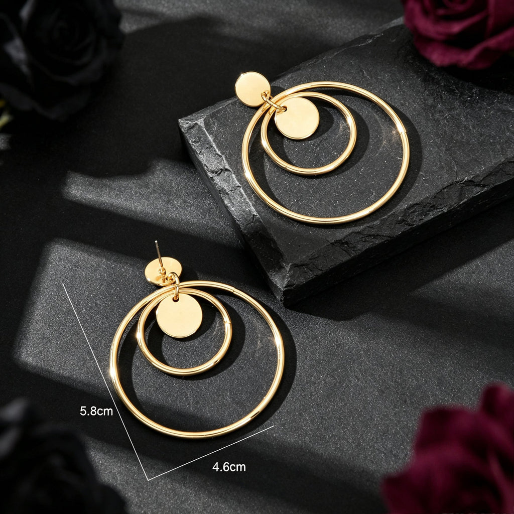 Gold double-hoop drop earrings, circular rings with stud and disc detail