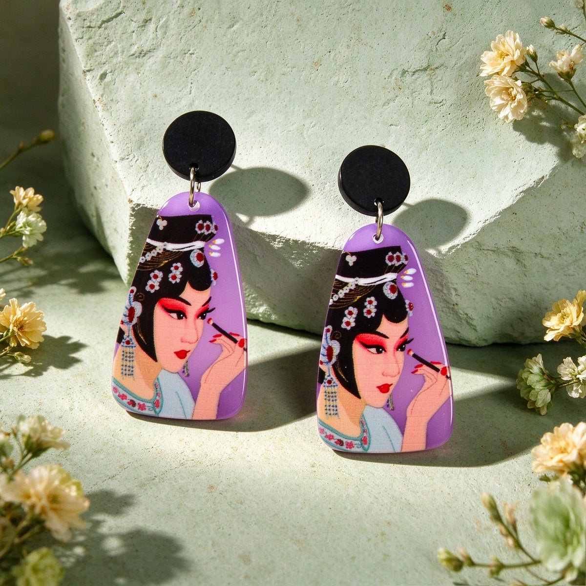Pair of purple opera figure dangle earrings with black round studs and portrait drops
