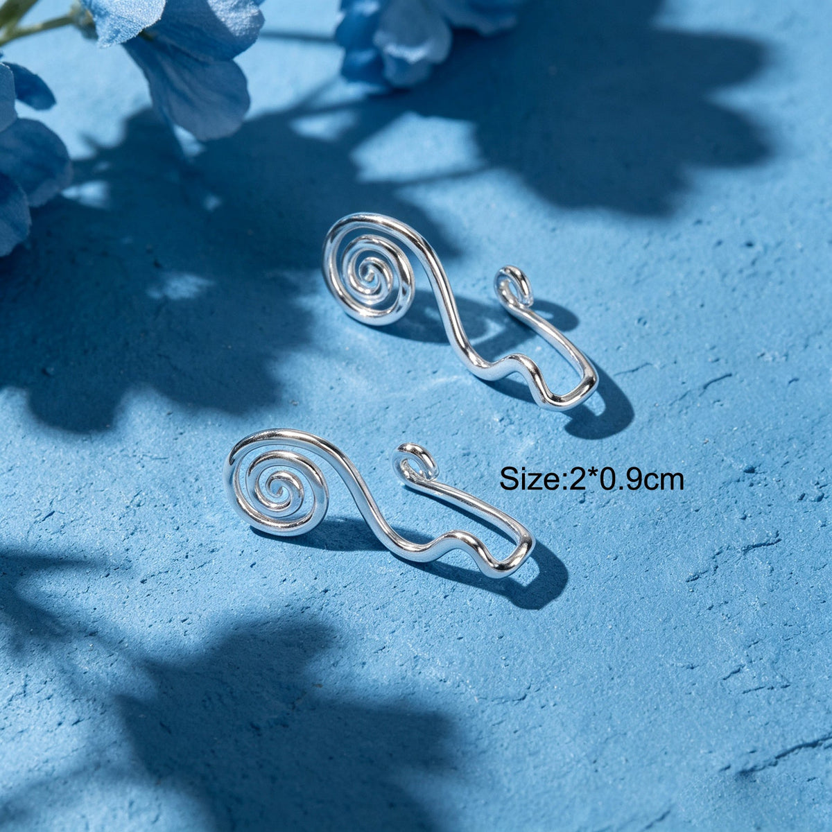 Pair of silver spiral ear cuffs with curved clip backs, no-piercing