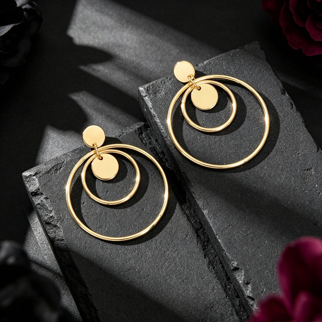 Gold double-hoop drop earrings with round discs and geometric rings