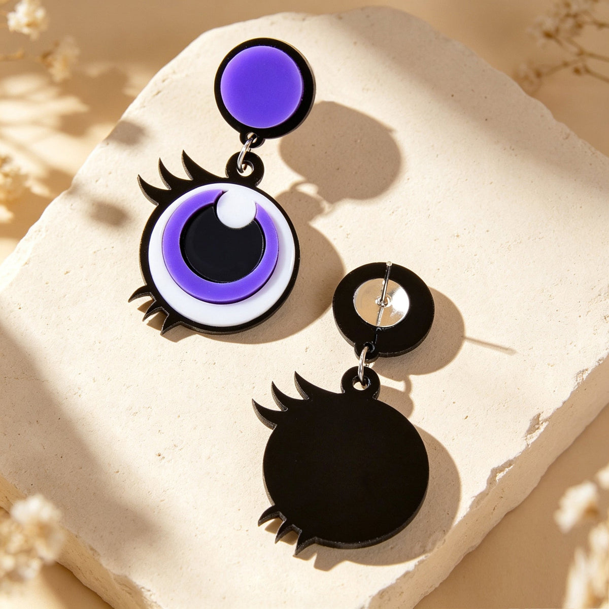 Purple cartoon big-eye acrylic dangle earrings with black and white eye details