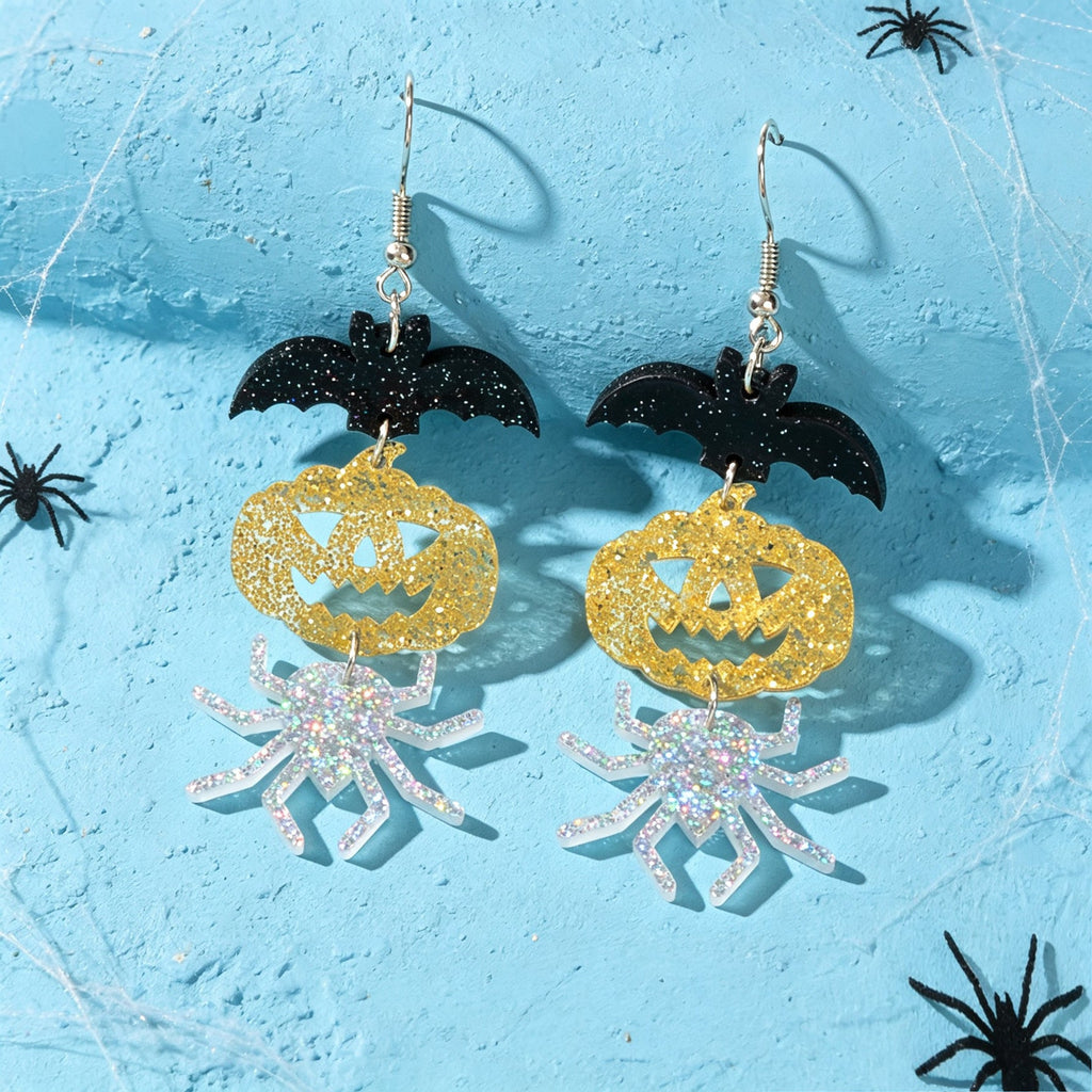Pair of Halloween drop earrings: black bat tops, gold glitter pumpkins, silver spider charms