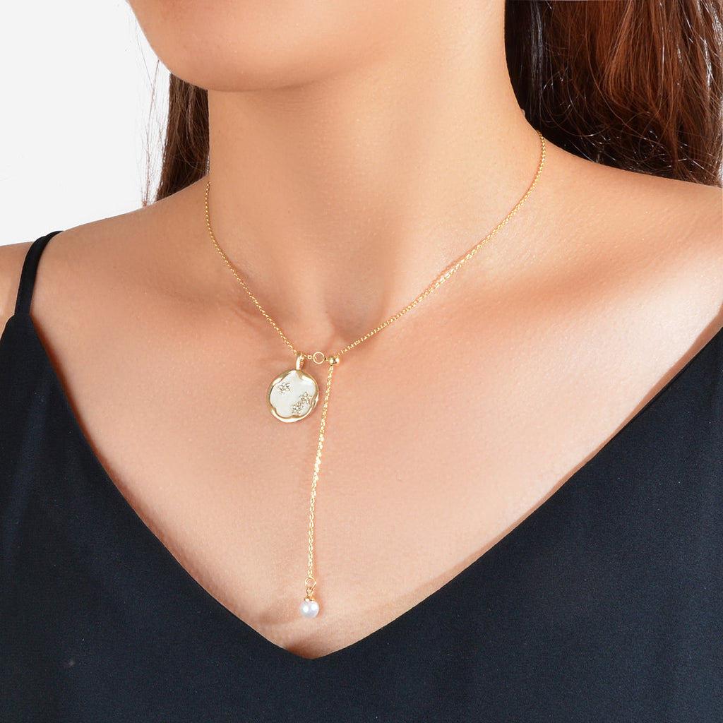 Gold-tone Y necklace with round white pearl pendant and dangling pearl charm