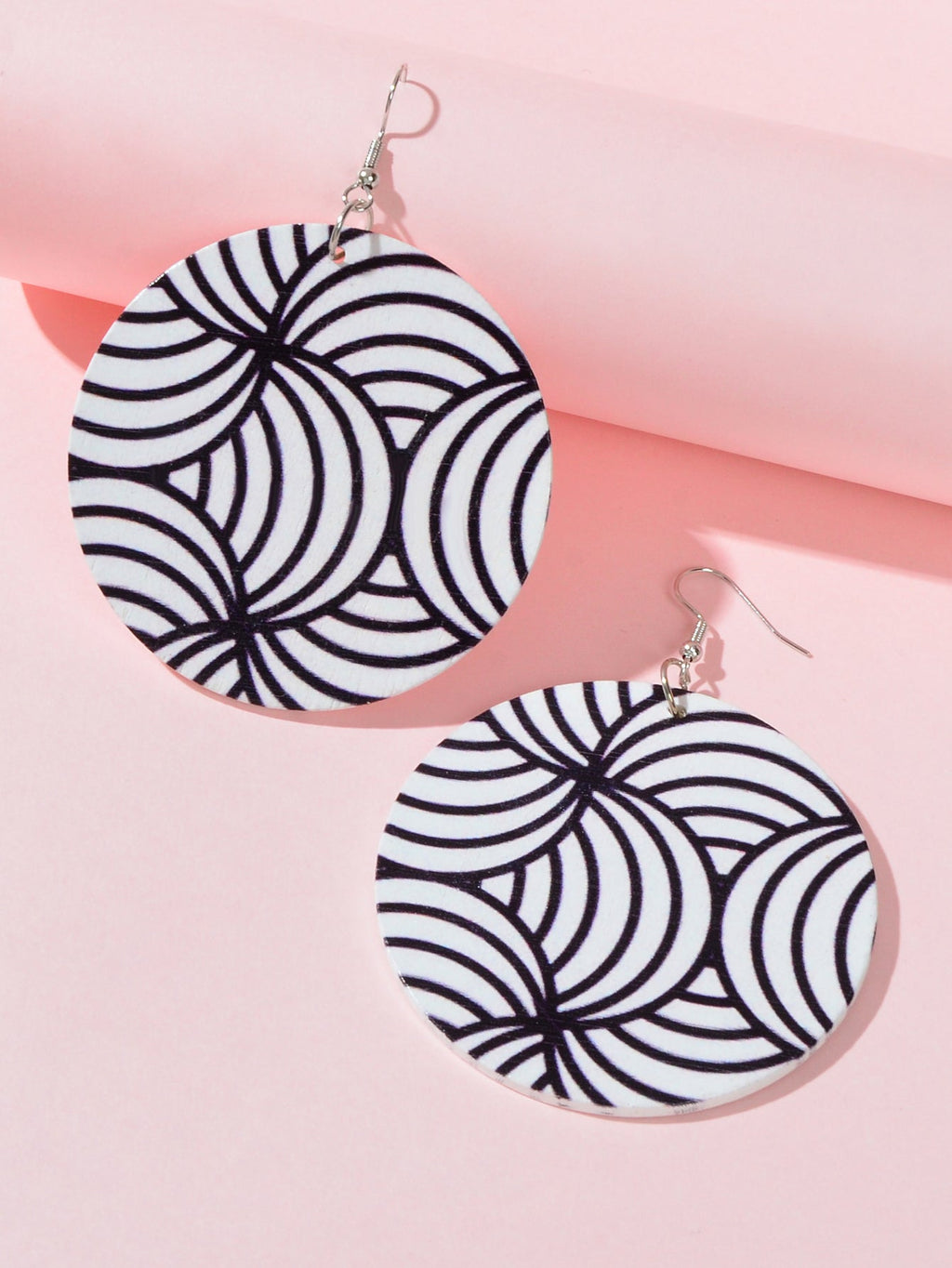 Pair of round zebra swirl earrings in black and white with silver hook