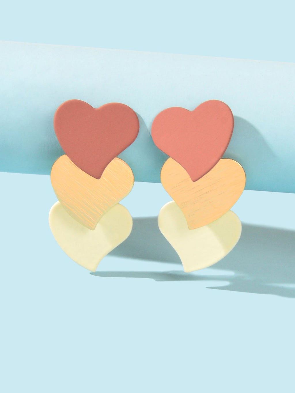 Layered heart dangle earrings with pink and cream hearts, gold-tone accents