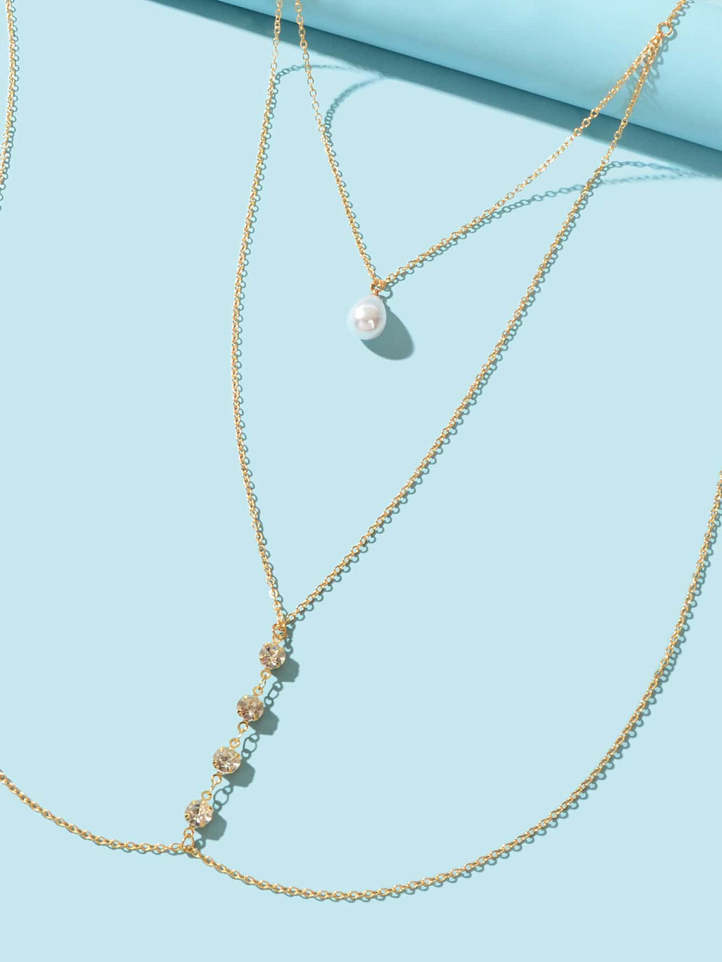 Gold pearl body chain with layered strands and teardrop pearl pendant clusters