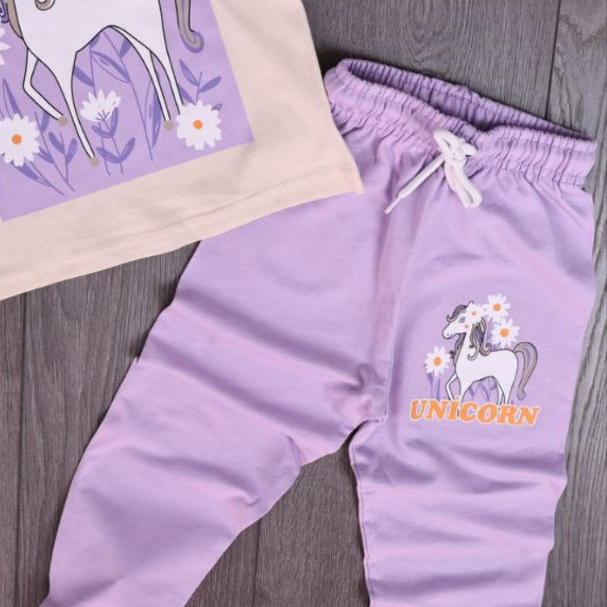 Unicorn Magic joggers set close-up: lavender joggers with drawstring and unicorn print