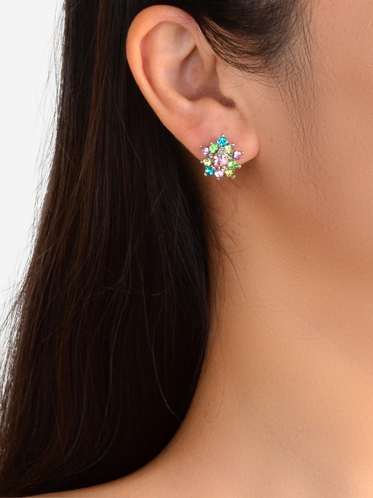 Colorful rhinestone star ear studs worn on ear with multicolor stones