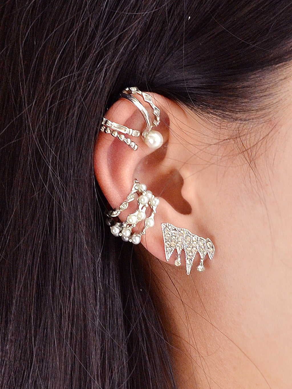 Silver clip-on ear cuffs on a model: rhinestone hoops with pearl-like beads
