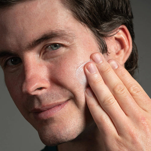 Anthony starter kit skincare use: man applying gel near ear with fingertips