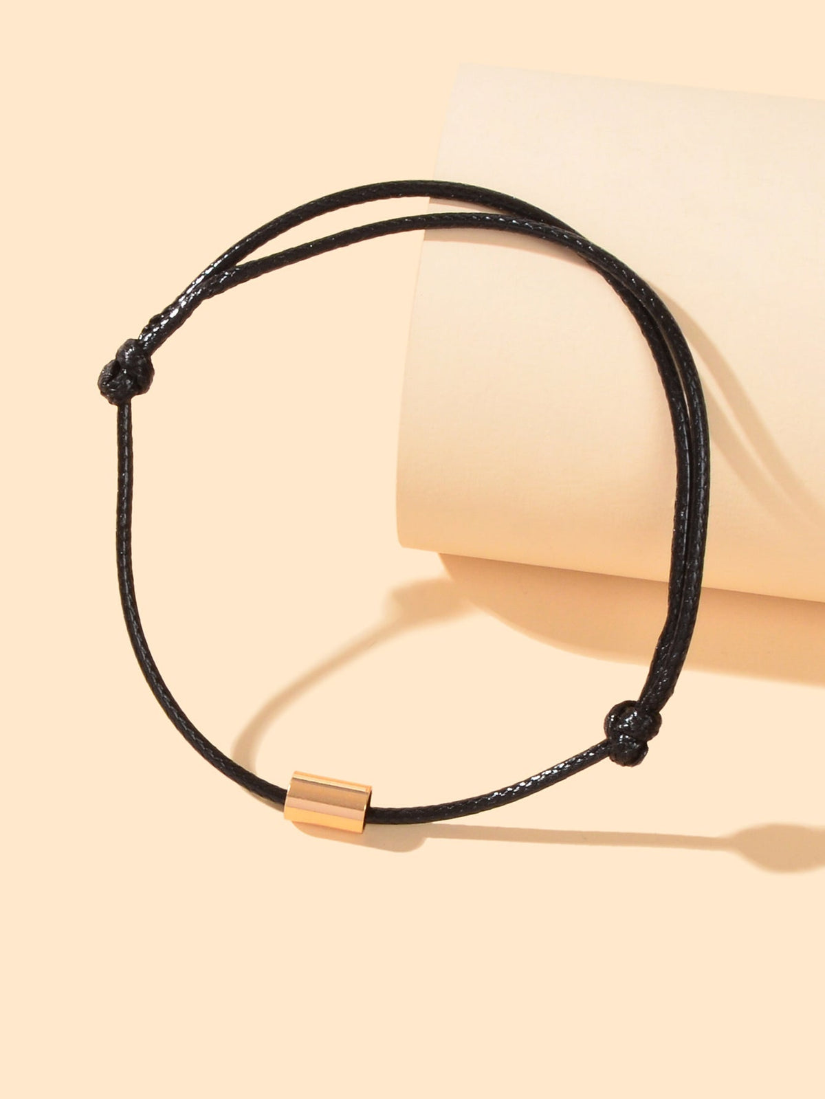 Black braided adjustable anklet bracelet with gold-tone tube clasp
