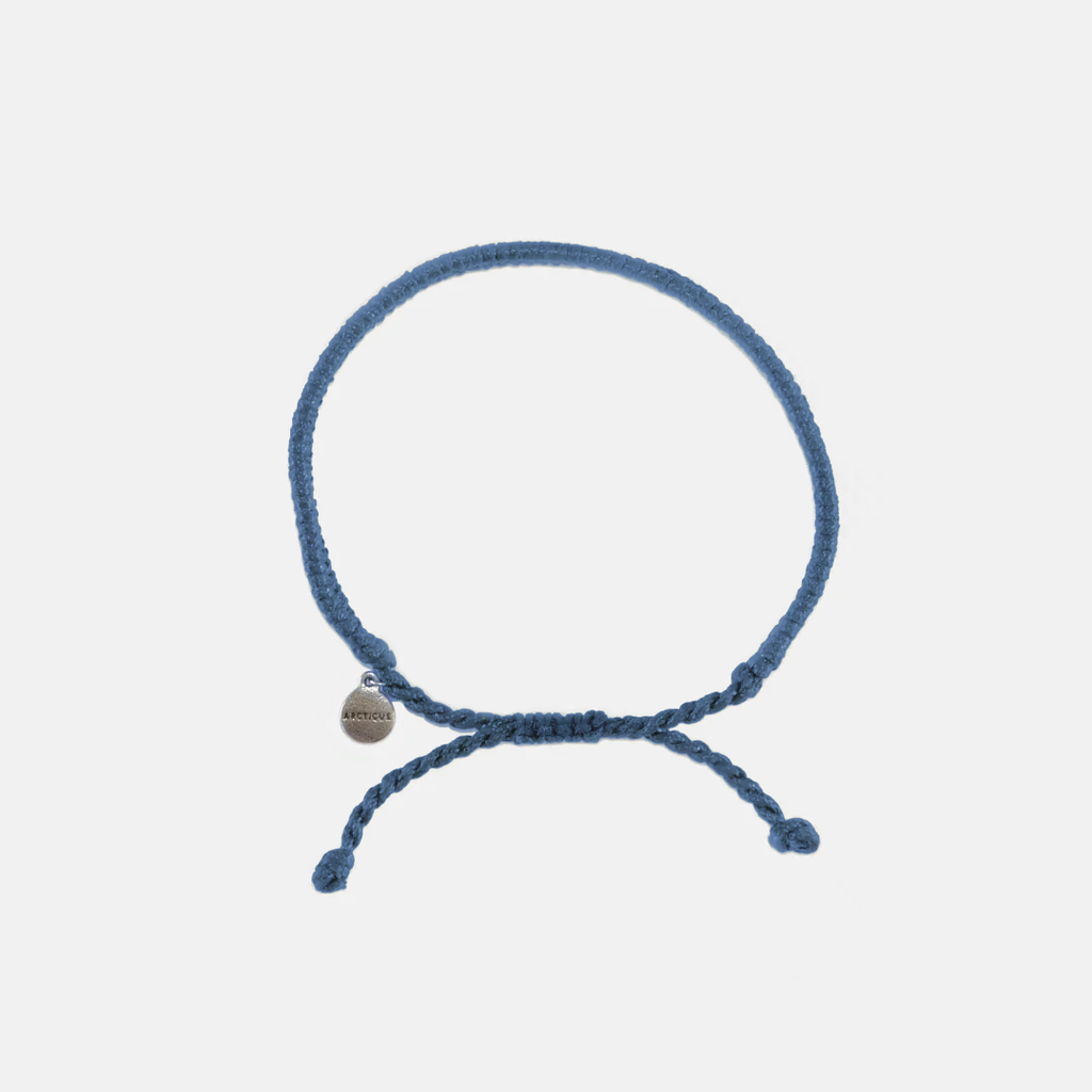 Blue braided adjustable bracelet with dangling ends and small round charm