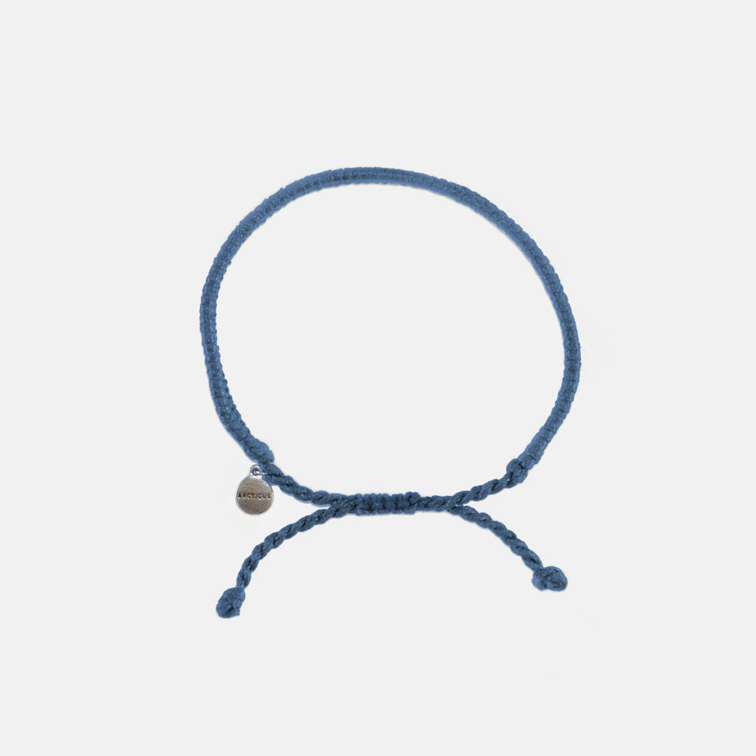 Blue braided adjustable bracelet with dangling ends and small round charm