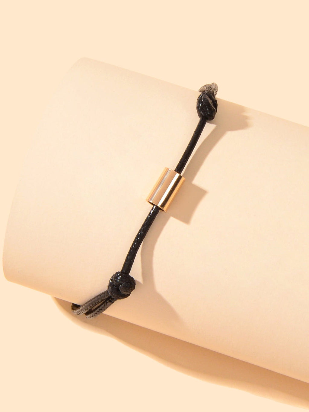 Black braided adjustable ankle bracelet with gold-tone tube clasp