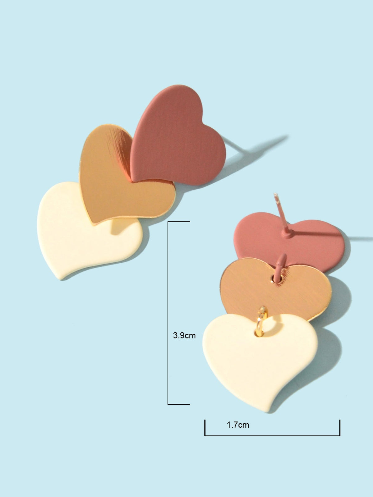 Layered heart dangle earrings with size details: pink, brown, and cream hearts