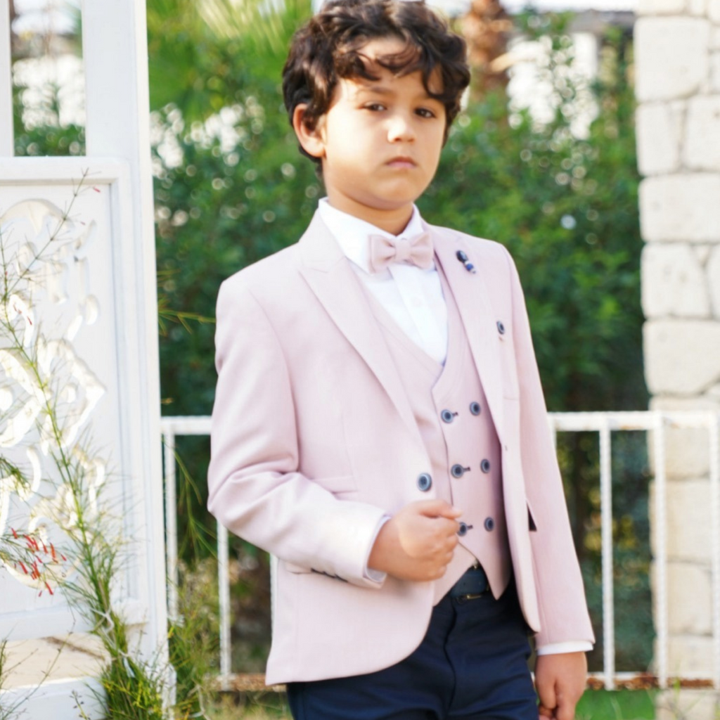 Boys blush formal 3-piece suit with bow tie, blazer and vest, paired with dark trousers