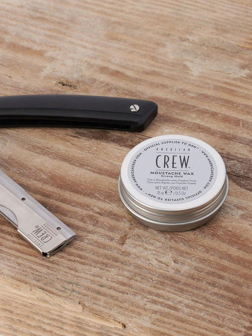 Moustache wax tin with metal cap on wooden surface, 15 g/0.5 oz