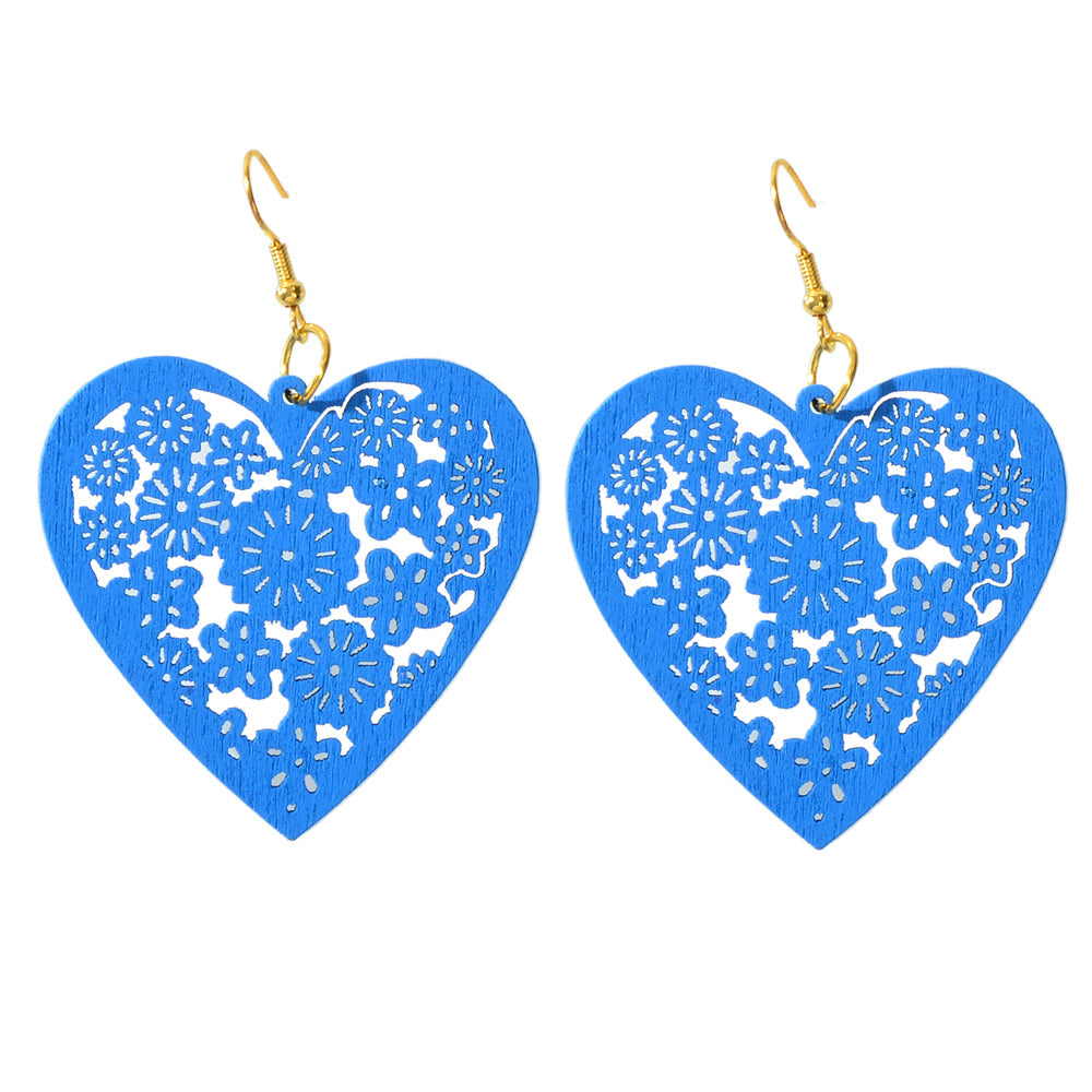 Blue heart dangle earrings set with intricate floral cutout and gold hooks