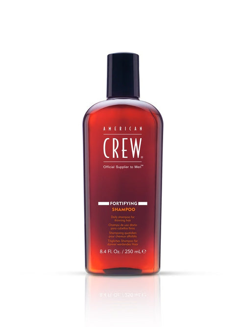 American Crew fortifying shampoo bottle, 250 ml, amber red liquid, black cap