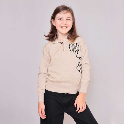 Kids beige sweater worn by child, long sleeves, buttoned neckline, kite graphic