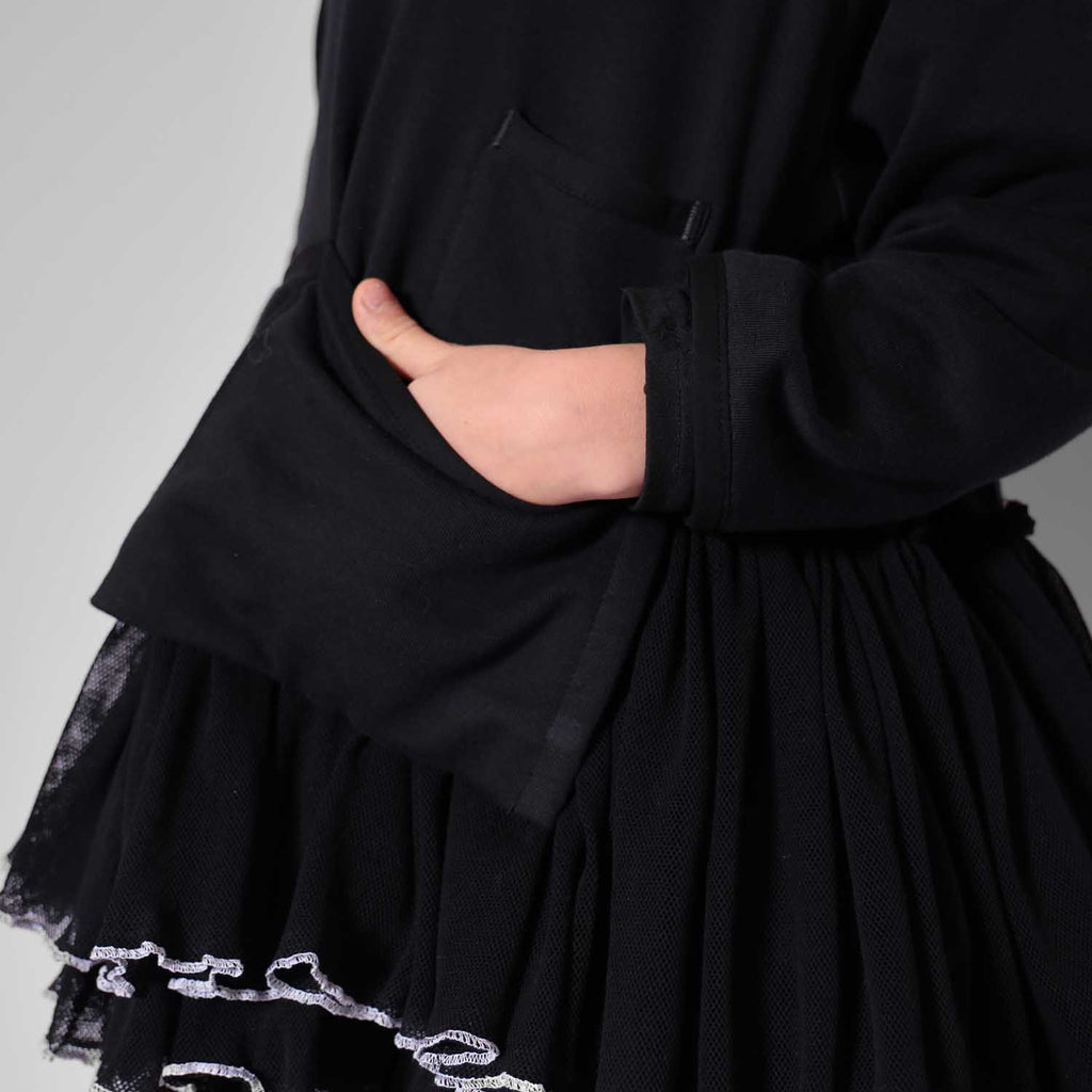 Black tulle hem with tiered ruffles and silver-white chain trim detail