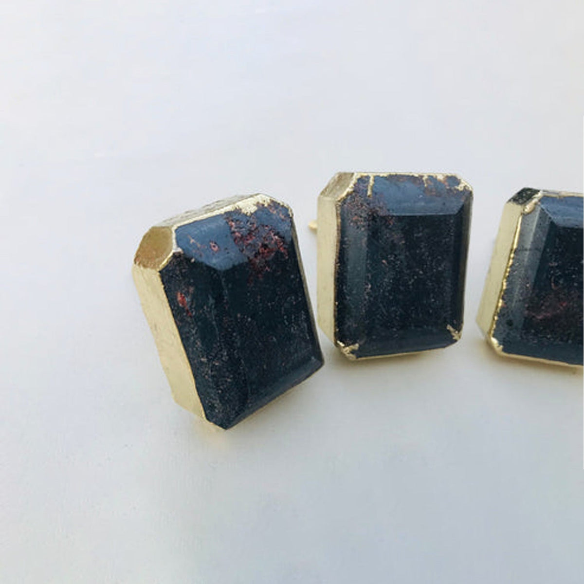 Dark gemstone cabinet drawer pull with gold-toned frame, faceted cube top and mounting post