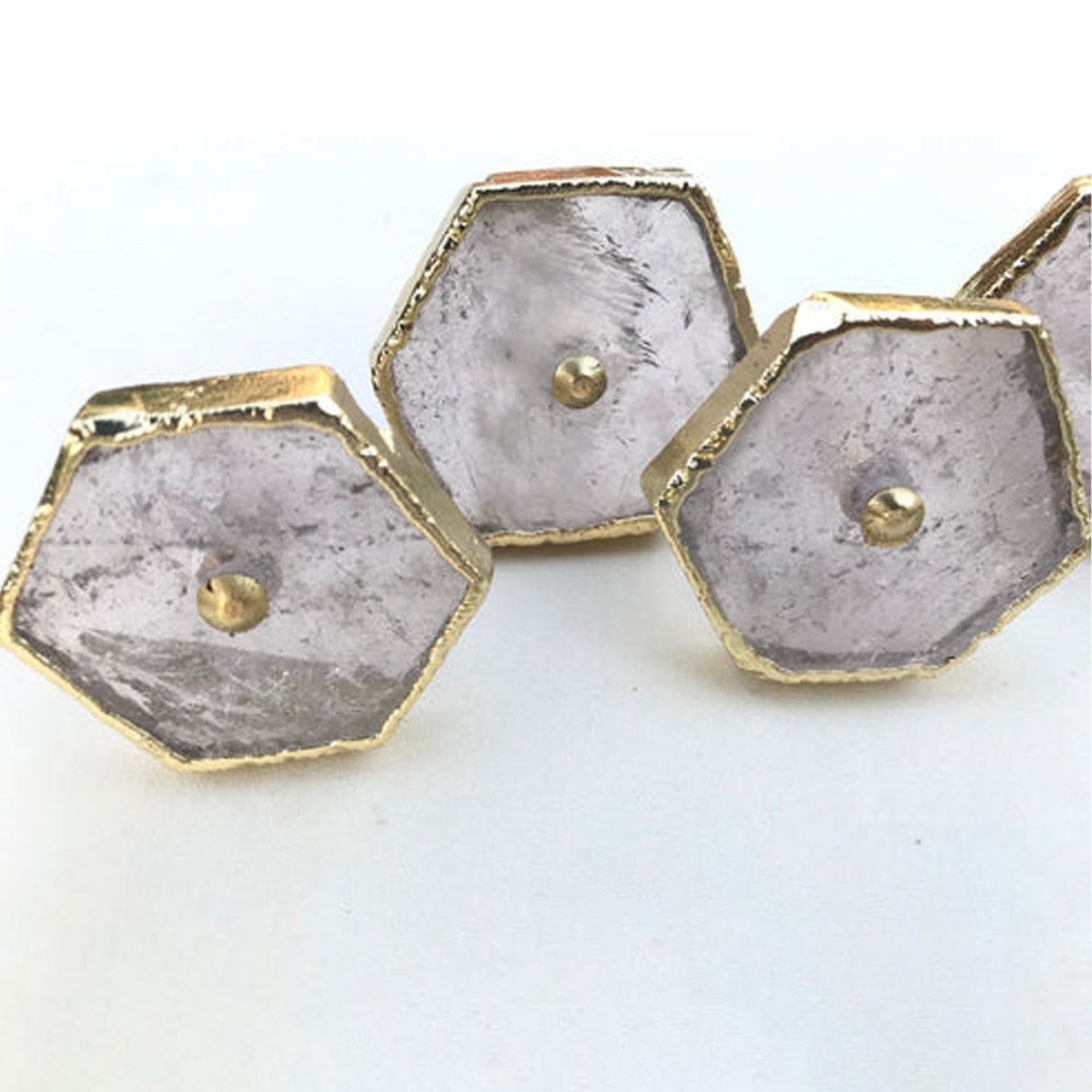 Hexagon cabinet drawer pull set with silver face plates and gold-tone trim, centered pins
