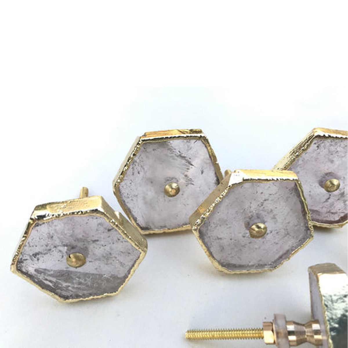 Hexagon cabinet drawer pull set with silver face plates and gold-tone borders, partial screw