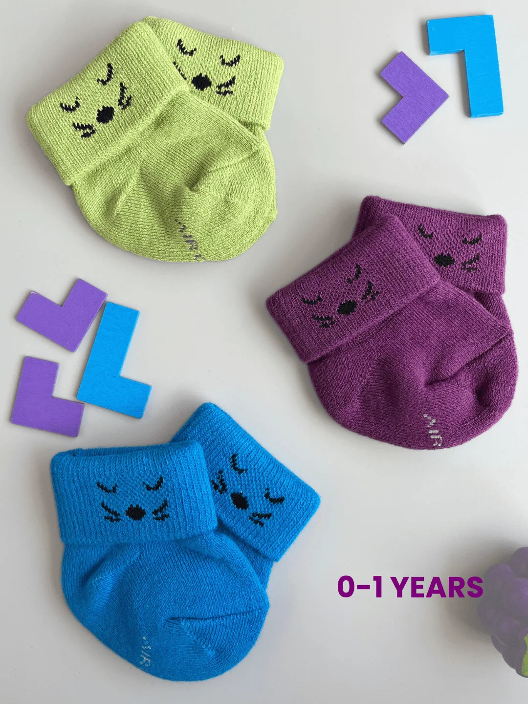 Air Garb baby combo socks for infants 0-1 years; a 6-pair collection arranged in a circle featuring animal faces like pink owl, brown giraffe, and white dog, alongside kitten-themed socks in purple, lime green, and blue.