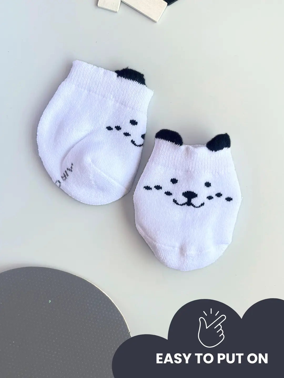 Air Garb baby combo socks for infants 0-1 years; a 6-pair collection arranged in a circle featuring animal faces like pink owl, brown giraffe, and white dog, alongside kitten-themed socks in purple, lime green, and blue.