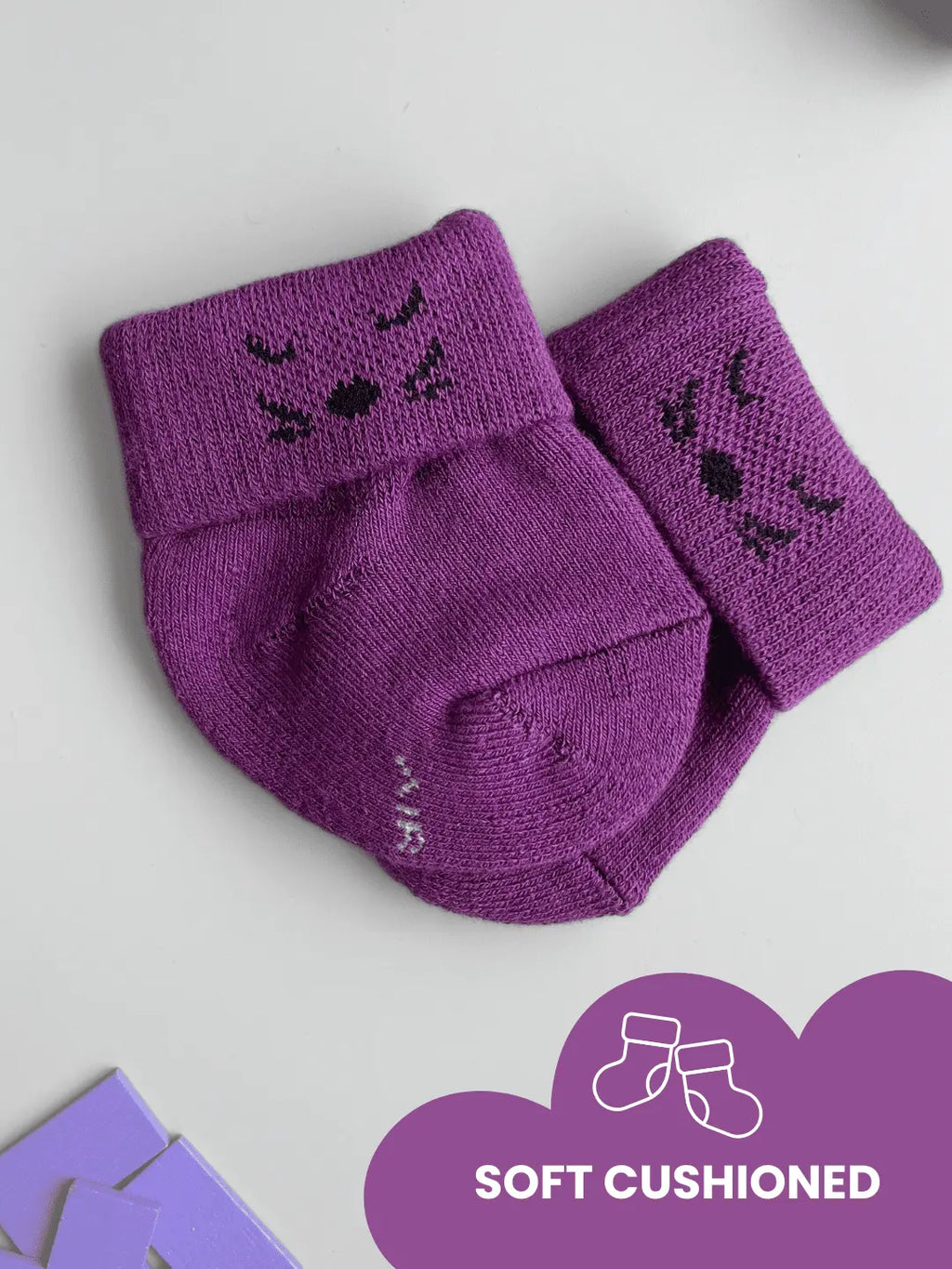 Air Garb high-quality cotton baby combo socks for ages 0-1 years; features pairs of socks in lime green, royal blue, and deep purple with embroidered kitten faces on the cuffs.