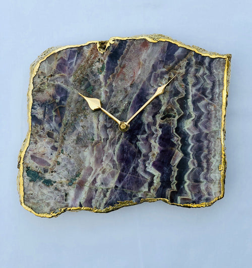 Amethyst wall clock with purple amethyst slab face, gold-tone hands and center
