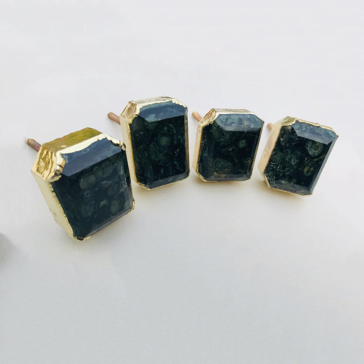Dark gemstone drawer pulls with gold vintage frames and hexagonal prism bases