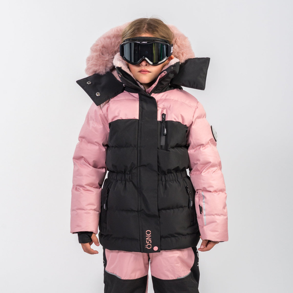 Kids blush and black snowsuit jacket with faux-fur trim, high collar, and goggles