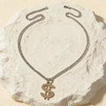 Silver-tone Cuban link chain necklace with large dollar sign pendant
