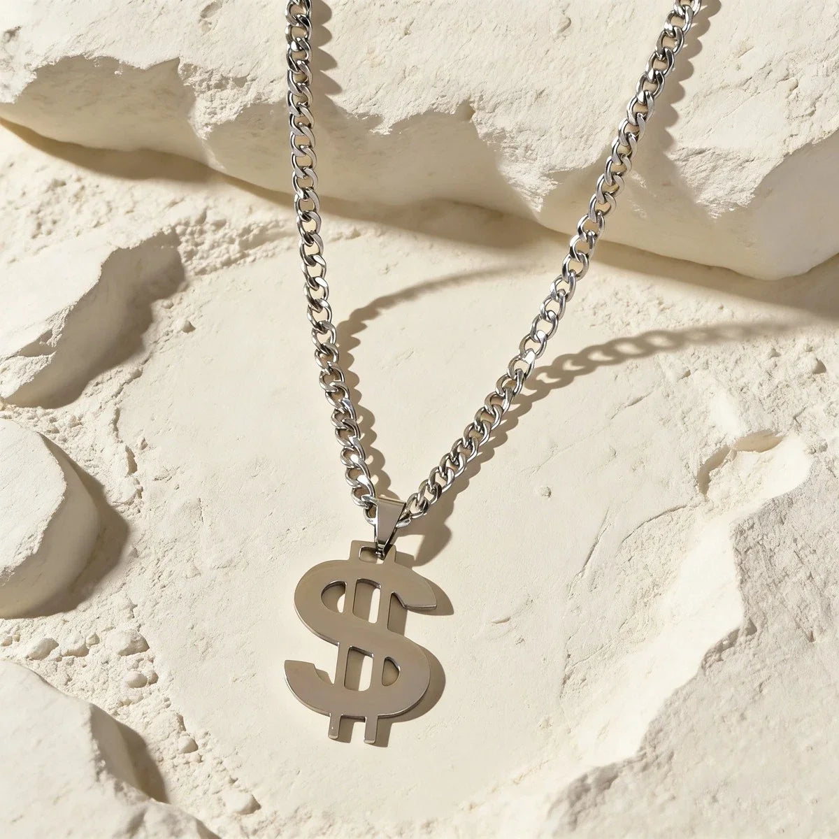 Silver-tone Cuban link chain necklace with dollar sign pendant, front view