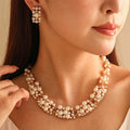 White pearl rhinestone necklace with matching stud earrings in gold-tone setting