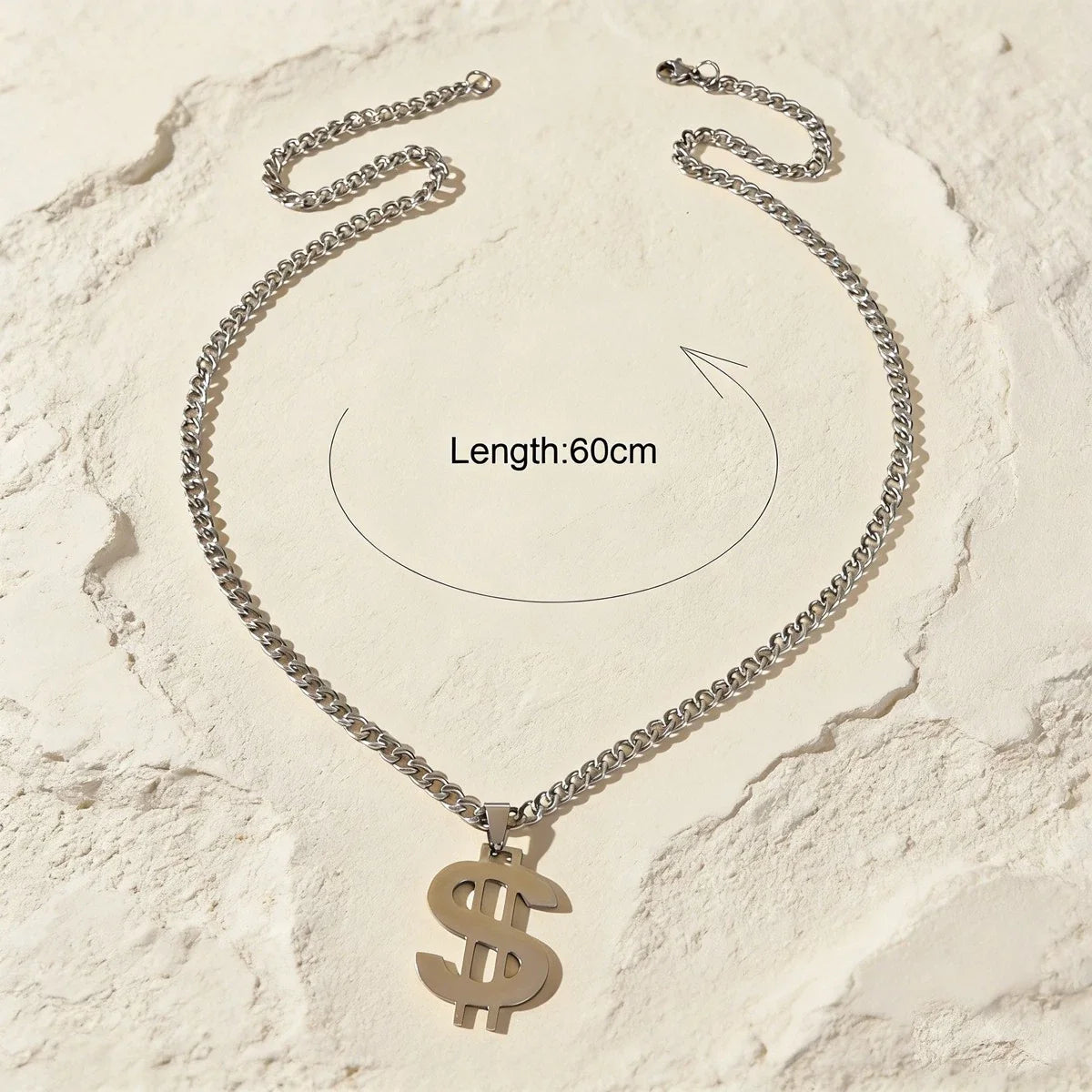 Silver-tone Cuban link chain necklace with dollar sign pendant, laid flat