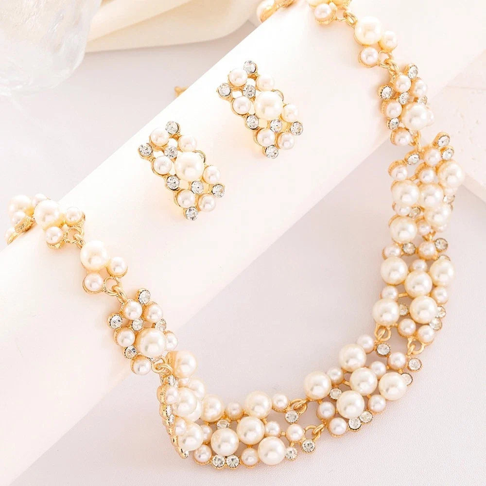 White pearl rhinestone necklace and stud earrings set with gold-tone links