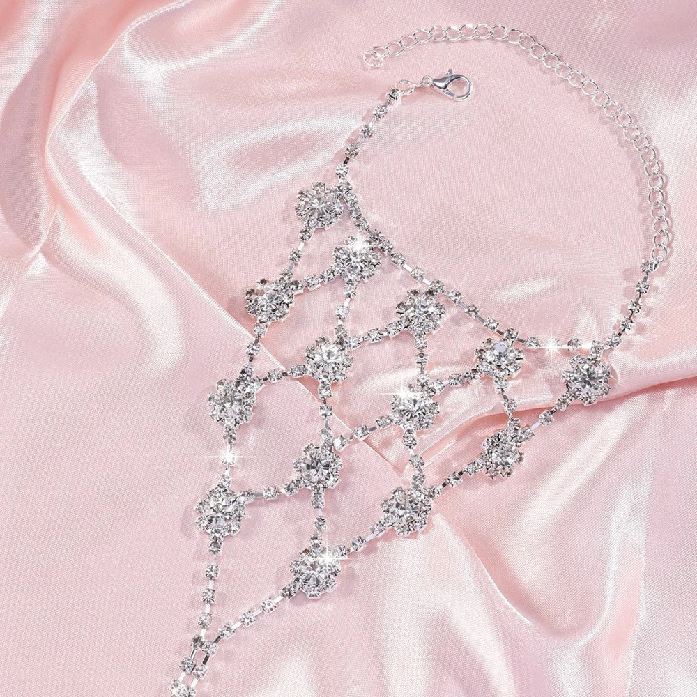Rhinestone flower bracelet connector with dangling floral drops on a soft satin fabric