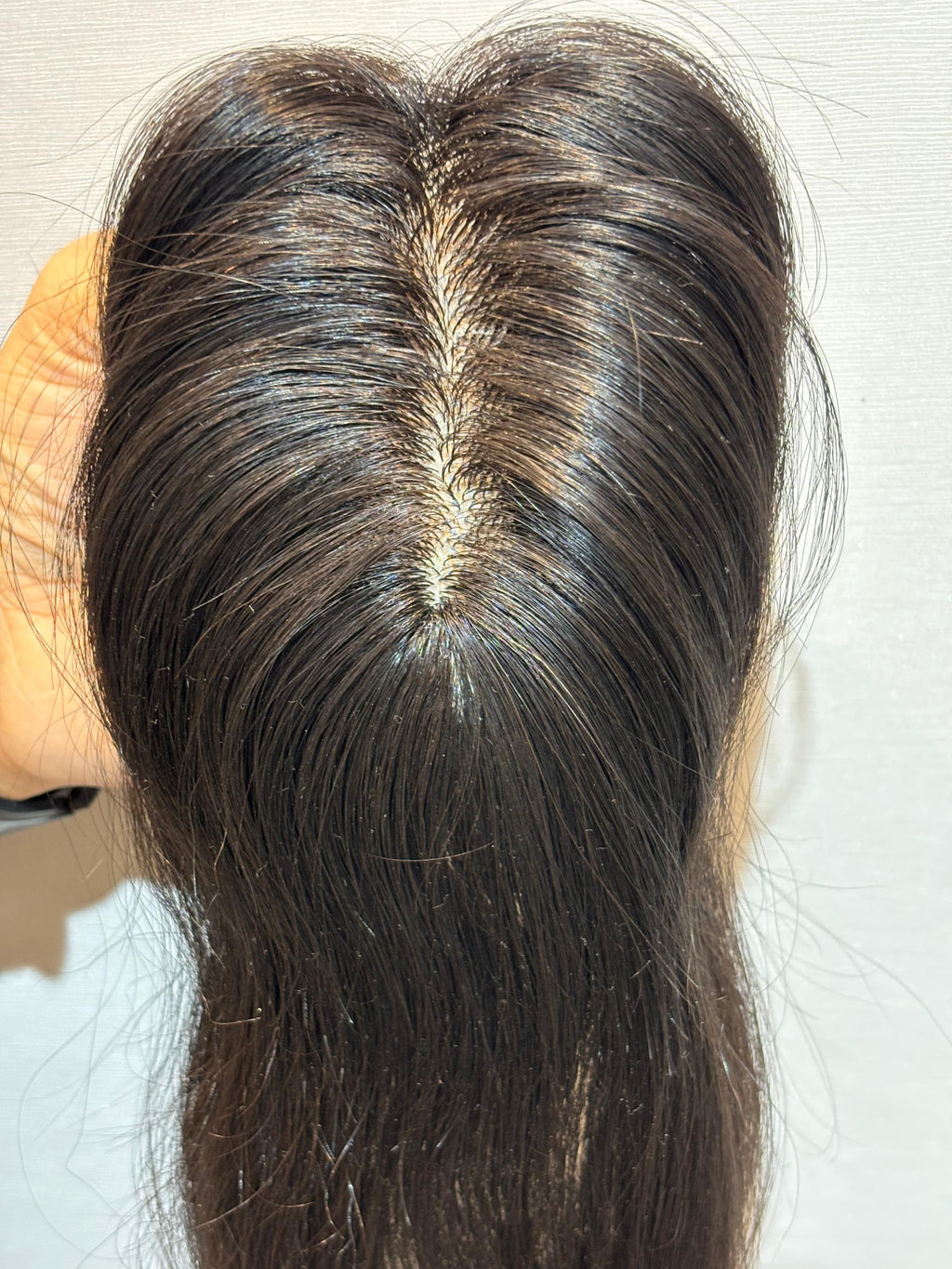 Natural black straight hair patch with highlighted center parting over silk base.