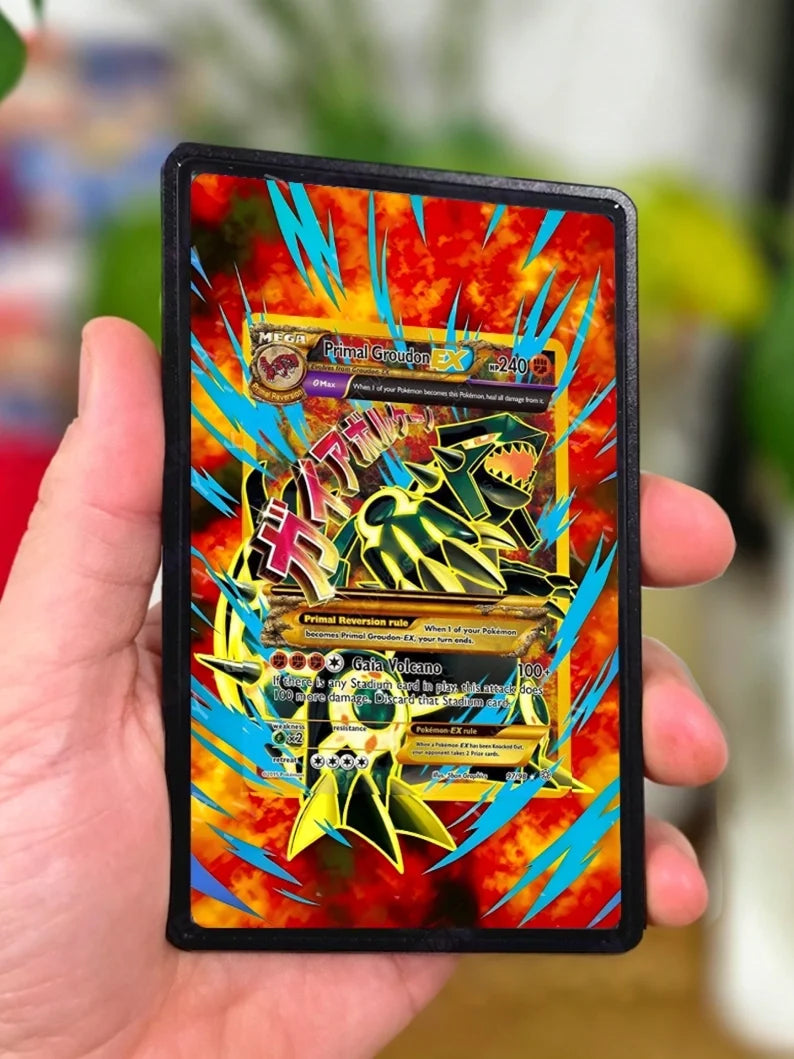 Primal Groudon EX trading card in a black sleeve, held in hand